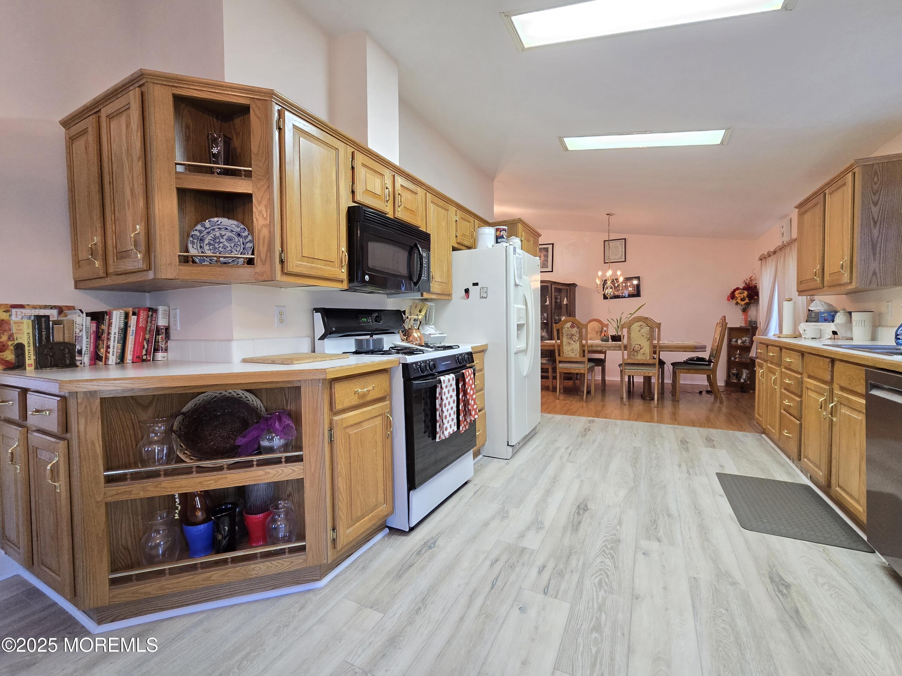 98 Woody Road Freehold, NJ 07728 - Photo 5 of 37 a kitchen with stainless steel appliances granite countertop a stove and cabinets