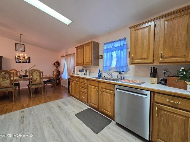 a kitchen with furniture wooden floor and a window