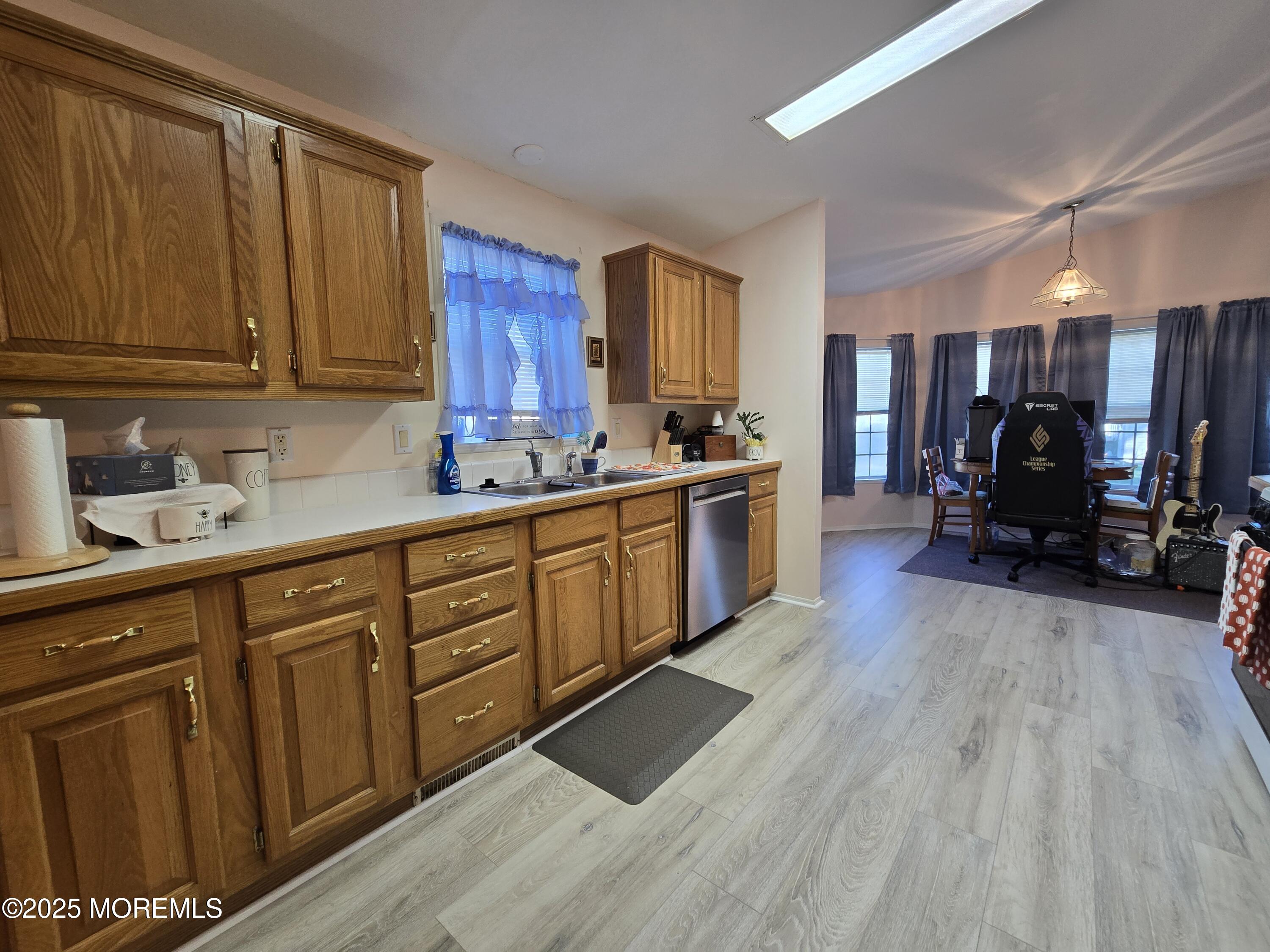 98 Woody Road Freehold, NJ 07728 - Photo 8 of 37 a large kitchen with stainless steel appliances wooden floors wooden cabinets a sink and a window