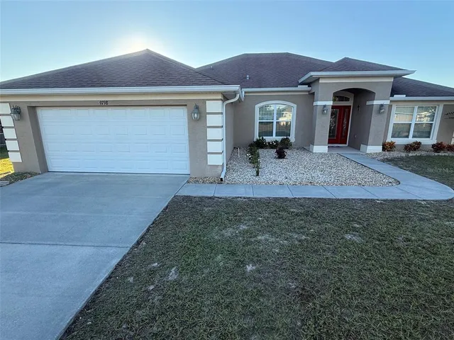 a front view of a house with a yard and garage