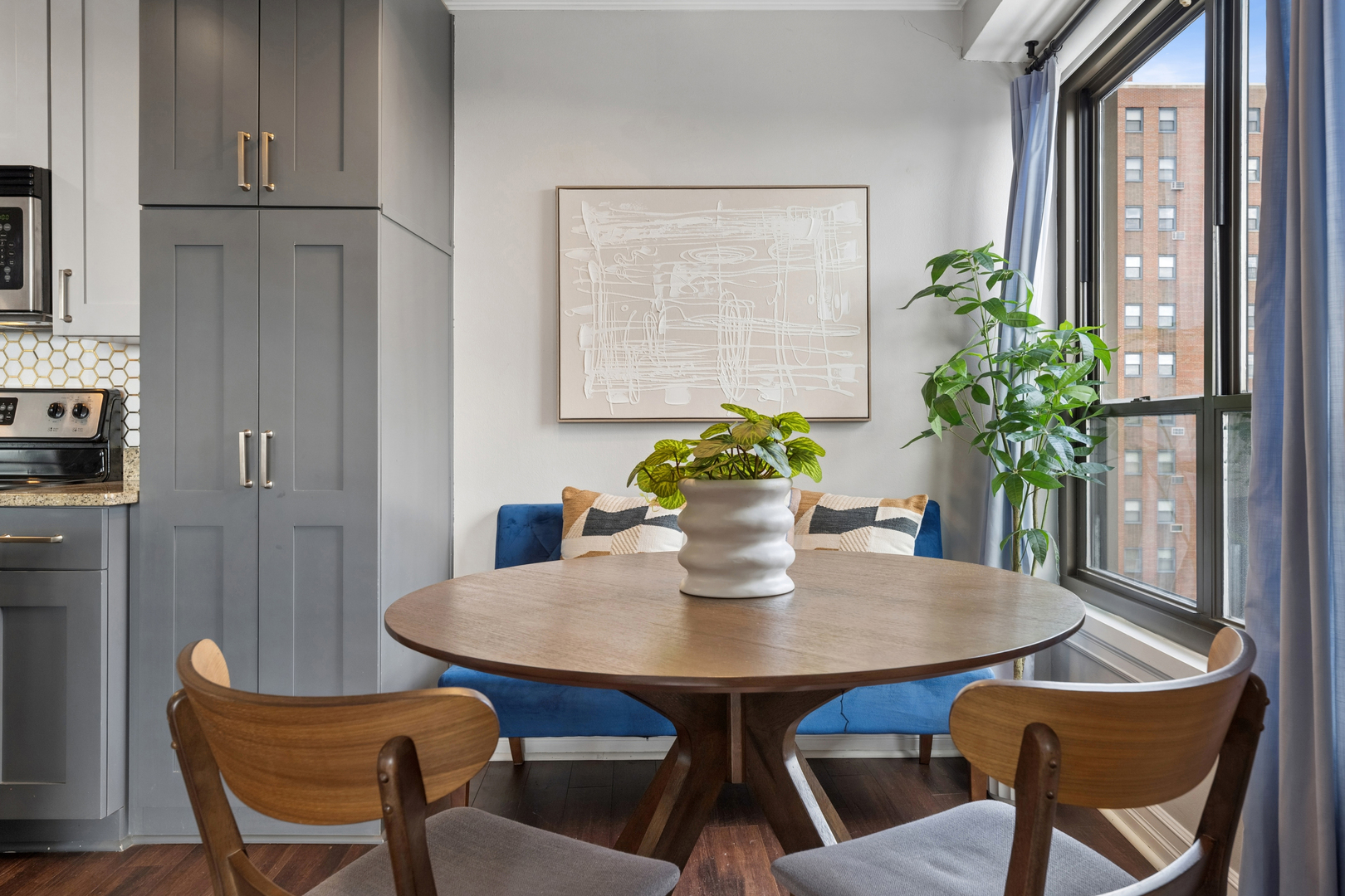 2930 North Sheridan Road, Unit 1301 Chicago, IL 60657 - Photo 11 of 27 a dining room with furniture and wooden floor