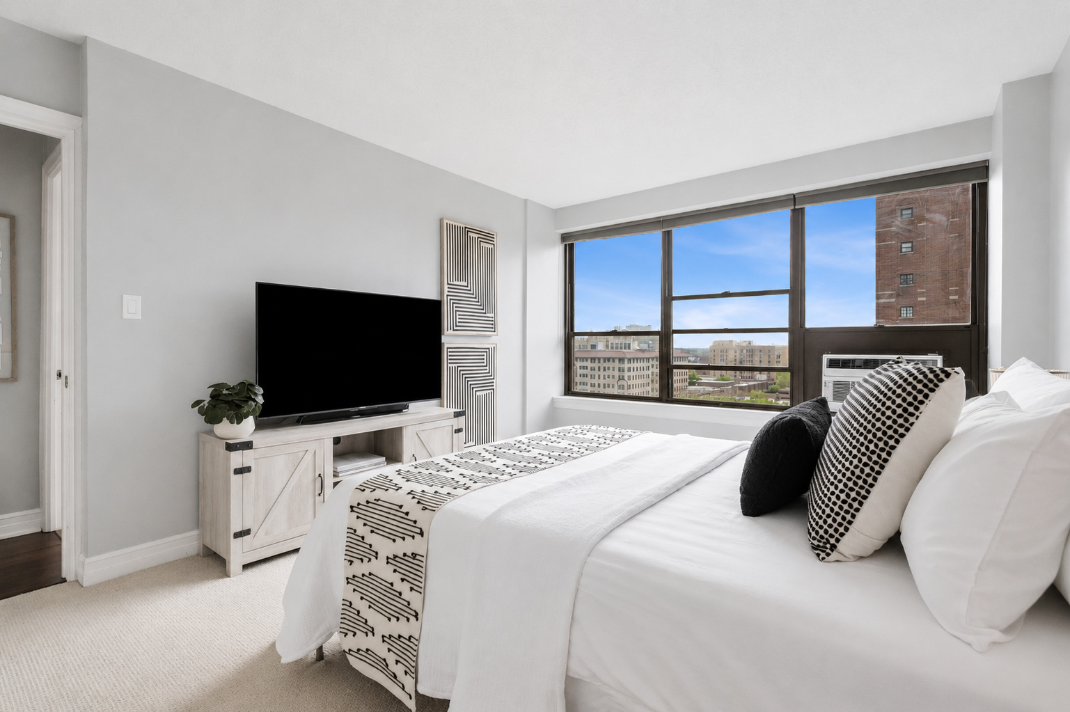 2930 North Sheridan Road, Unit 1301 Chicago, IL 60657 - Photo 14 of 27 a bedroom with a bed and a flat screen tv