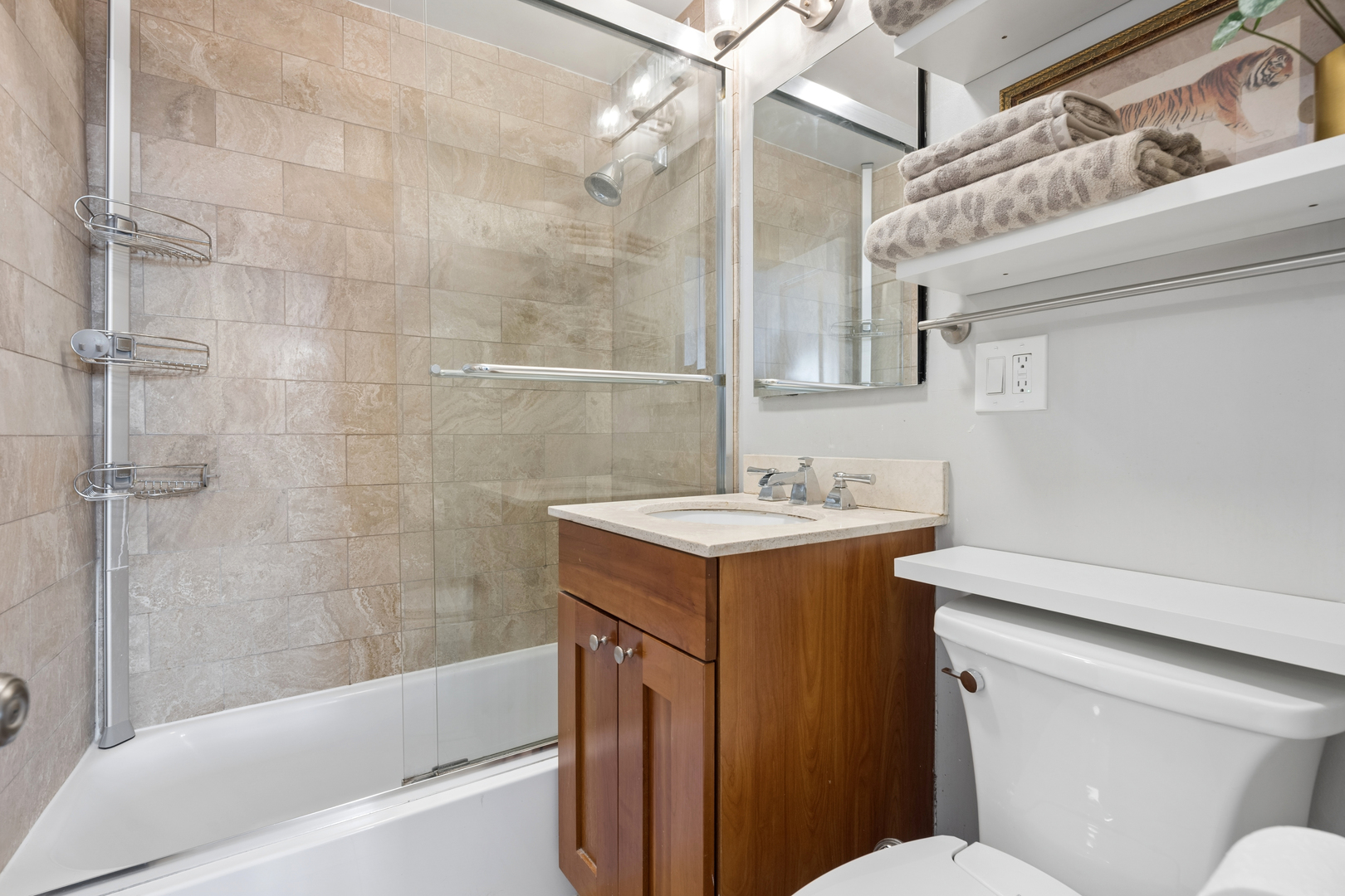 2930 North Sheridan Road, Unit 1301 Chicago, IL 60657 - Photo 16 of 27 a bathroom with a sink toilet vanity and shower