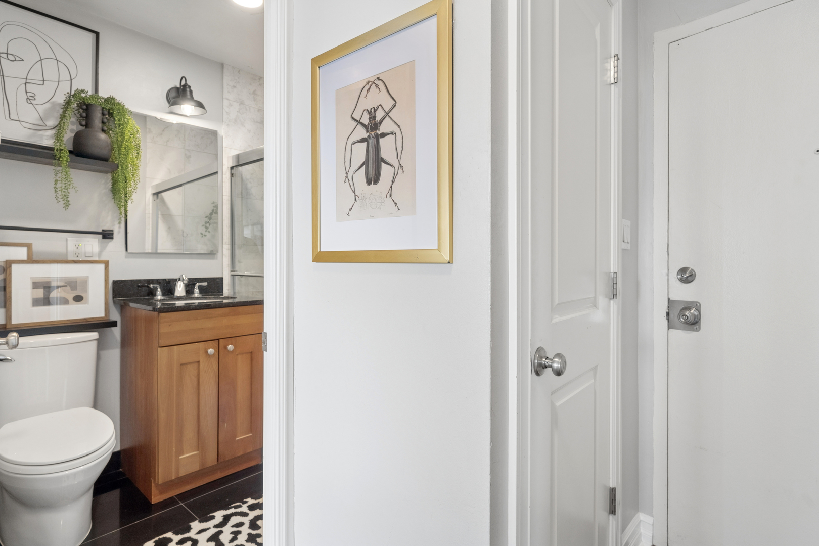 2930 North Sheridan Road, Unit 1301 Chicago, IL 60657 - Photo 19 of 27 a bathroom with a toilet sink and mirror
