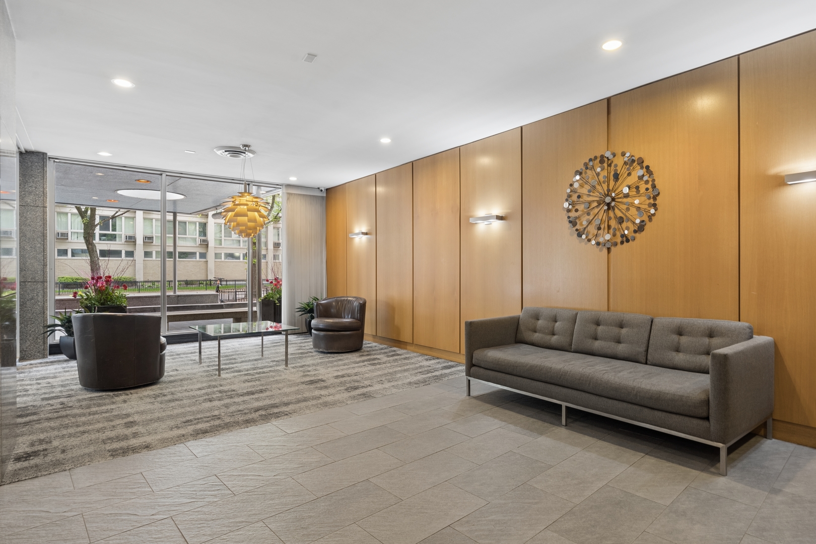 2930 North Sheridan Road, Unit 1301 Chicago, IL 60657 - Photo 27 of 27 a living room with couches and kitchen view with wooden floor