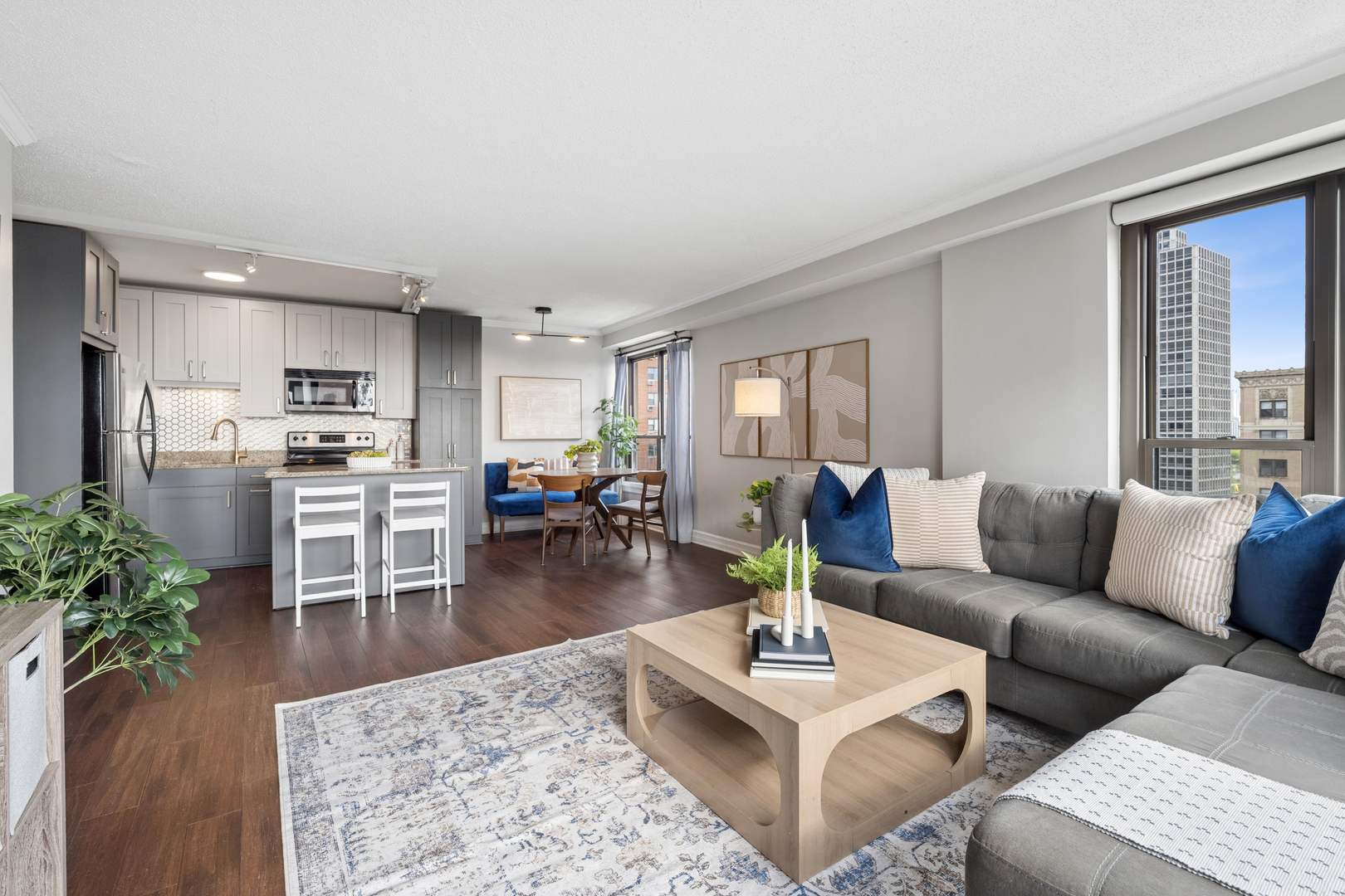 2930 North Sheridan Road, Unit 1301 Chicago, IL 60657 - Photo 6 of 27 a living room with furniture wooden floor and a kitchen