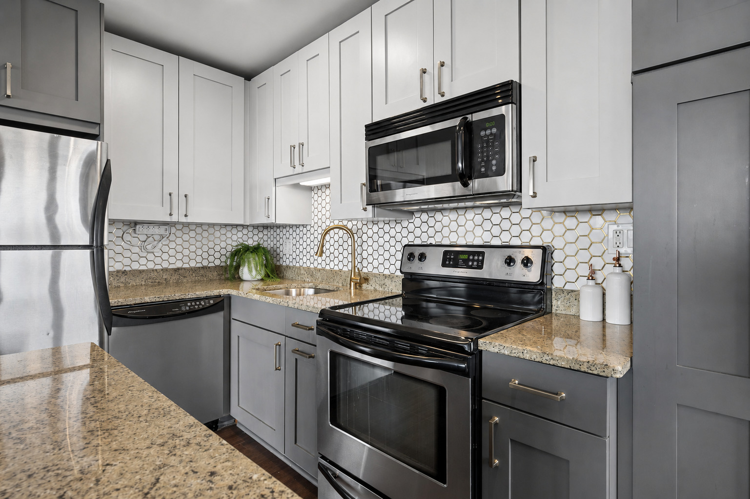2930 North Sheridan Road, Unit 1301 Chicago, IL 60657 - Photo 9 of 27 a kitchen with a stove and a microwave