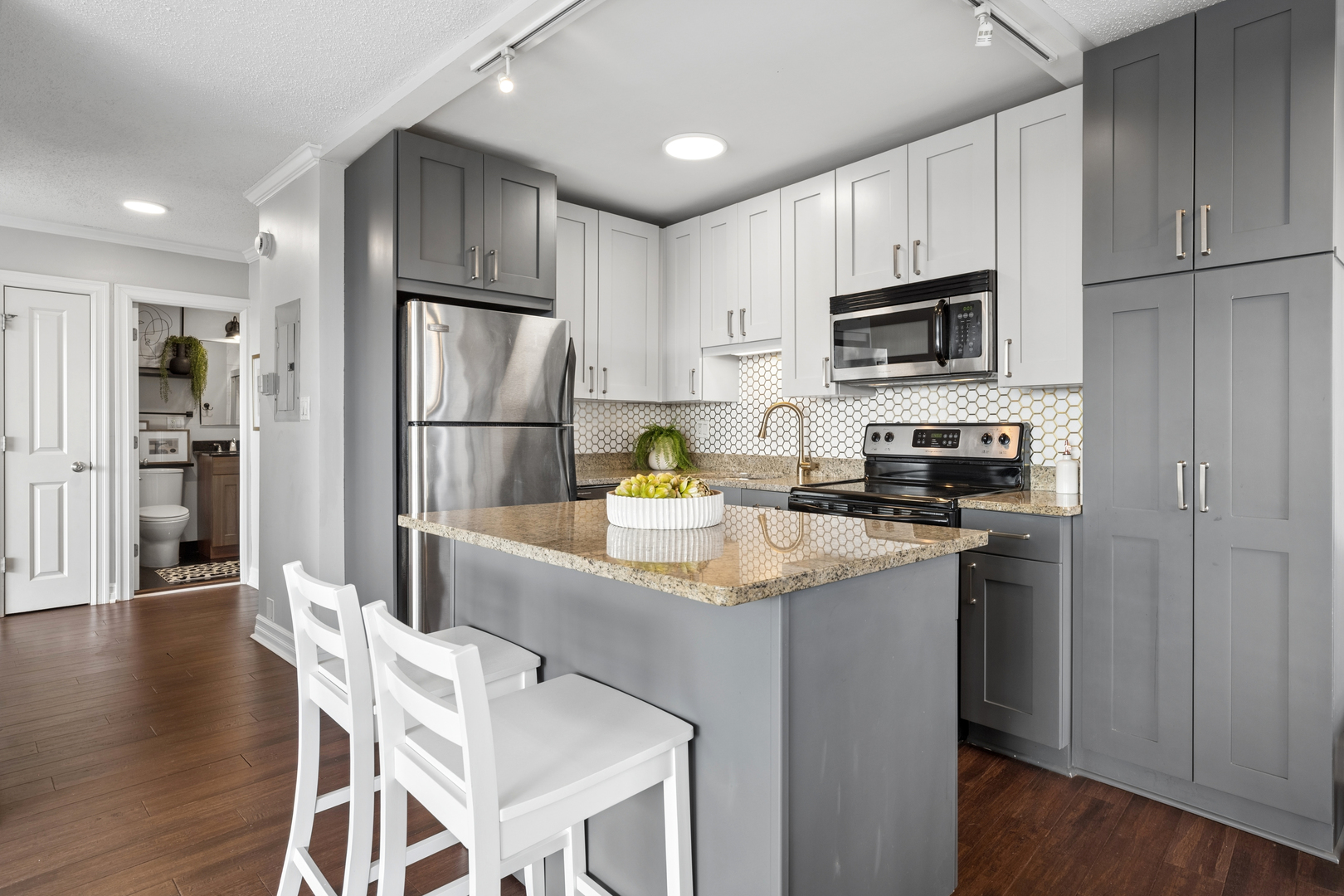 2930 North Sheridan Road, Unit 1301 Chicago, IL 60657 - Photo 10 of 27 a kitchen with a refrigerator microwave and stove top oven