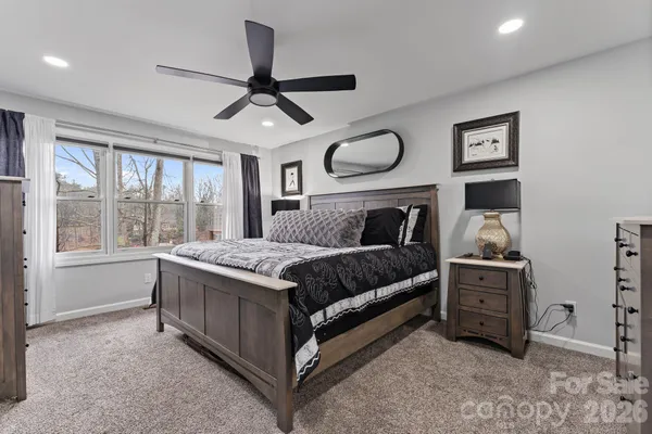 a bedroom with a bed closet and window