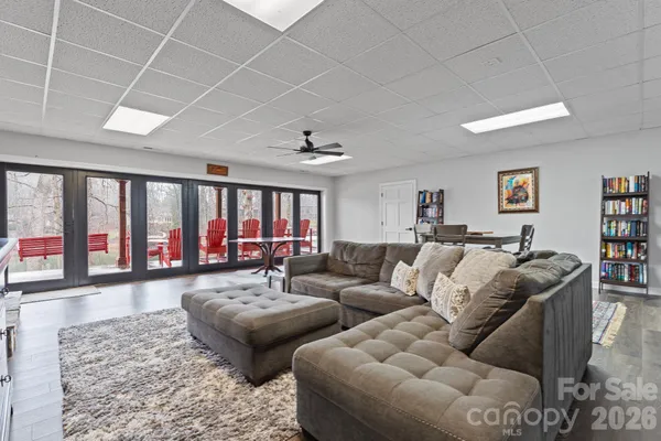 a living room with furniture ceiling fan and a rug