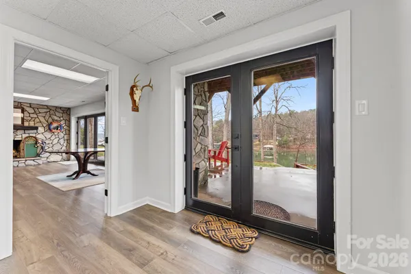 a view of a livingroom with wooden floor and a chandelier