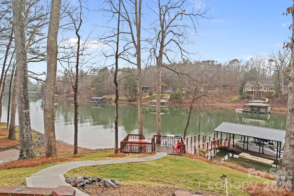 a view of a lake with a bench and trees