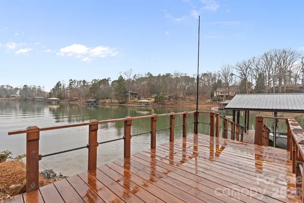 a view of a balcony with lake view and wooden floor