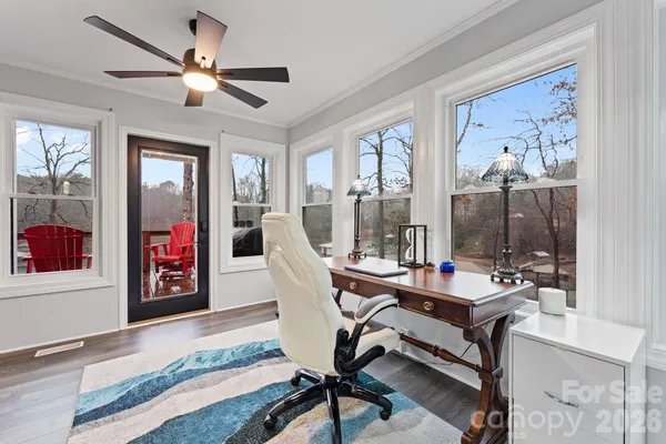 a living room with furniture a flat screen tv and a window