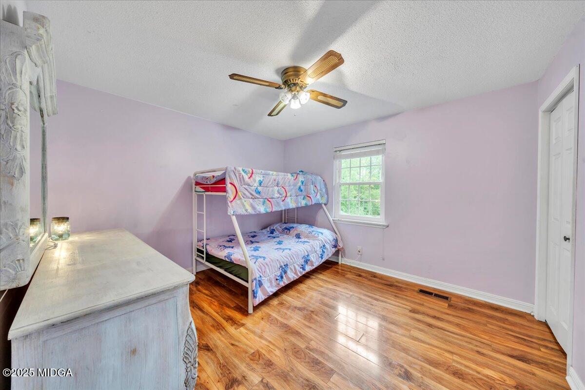 354 Pineview Road Gray, GA 31032 - Photo 18 of 44 a bedroom with a bed and a chandelier