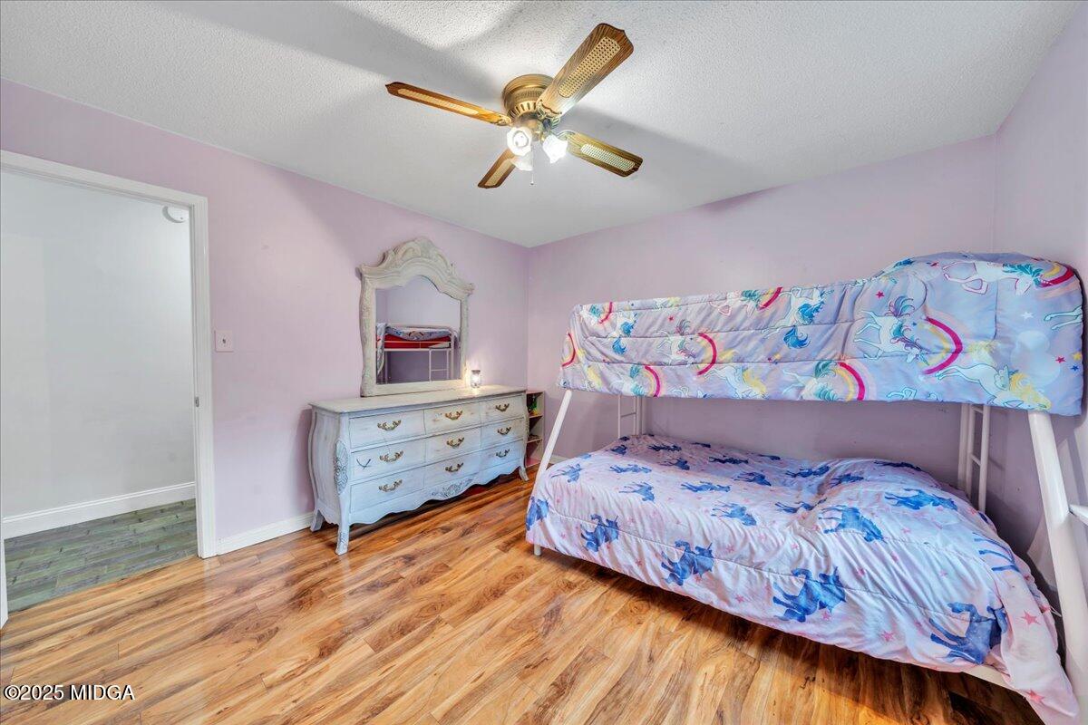 354 Pineview Road Gray, GA 31032 - Photo 19 of 44 a bedroom with a bed and wooden floor