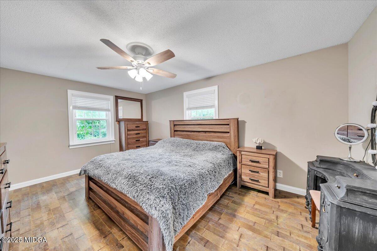 354 Pineview Road Gray, GA 31032 - Photo 20 of 44 a bedroom with a bed and a chandelier