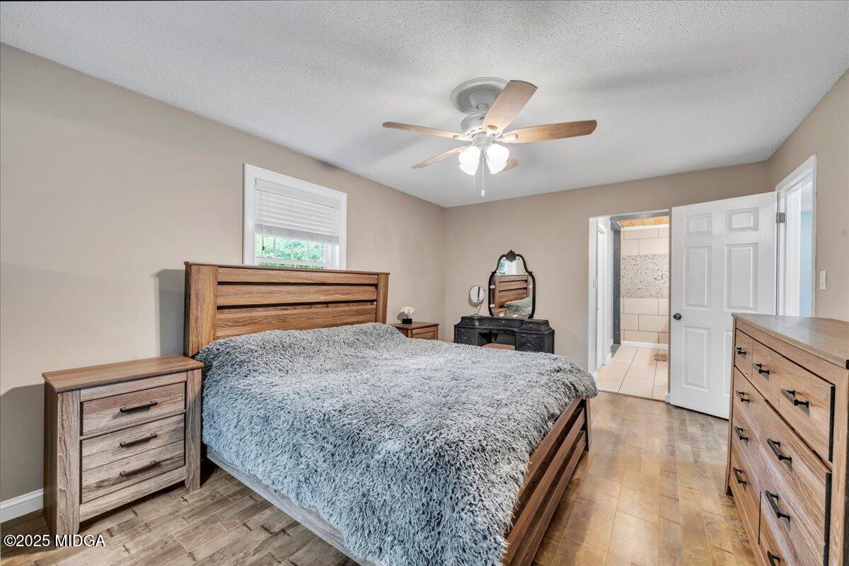 354 Pineview Road Gray, GA 31032 - Photo 21 of 44 a bedroom with a bed and a chandelier