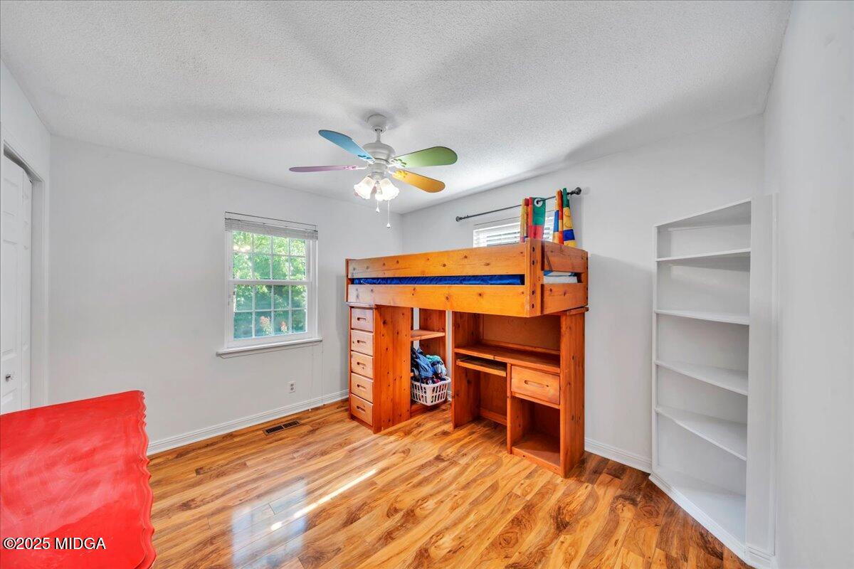 354 Pineview Road Gray, GA 31032 - Photo 25 of 44 a bedroom with a bed and a chandelier