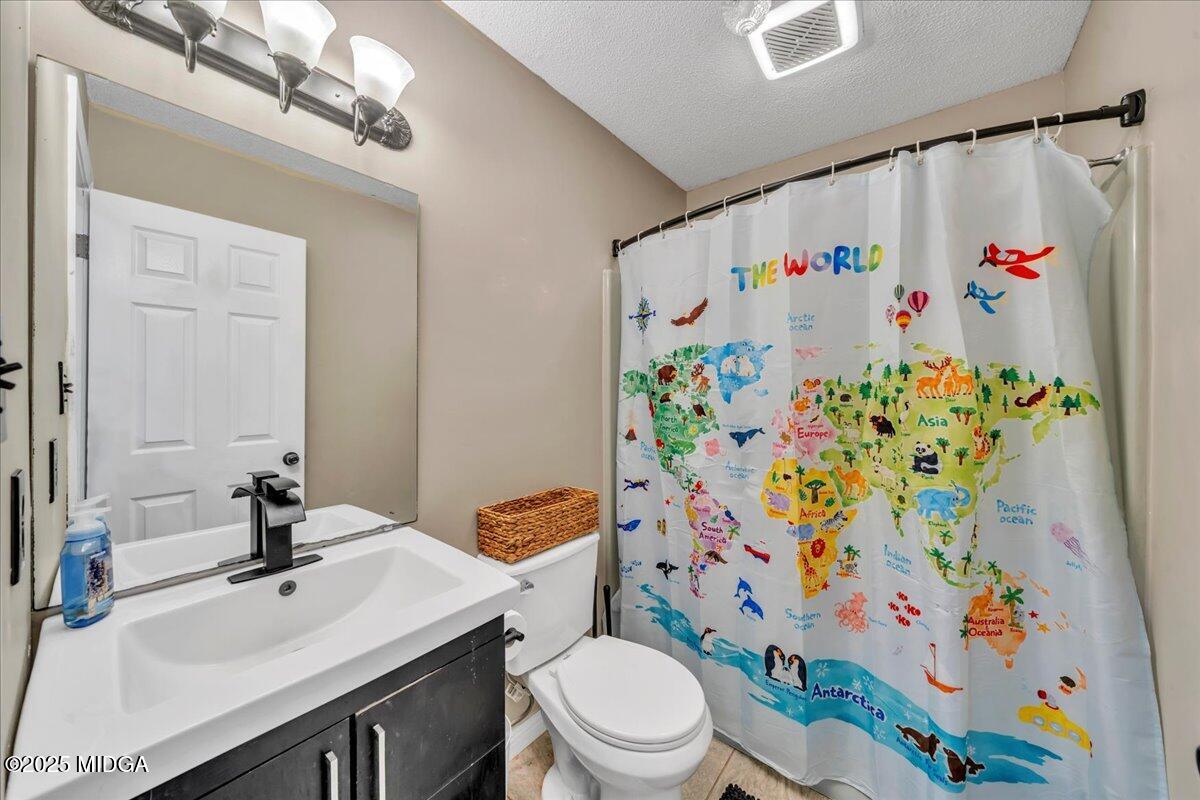 354 Pineview Road Gray, GA 31032 - Photo 27 of 44 a bathroom with a sink a toilet and a shower curtain