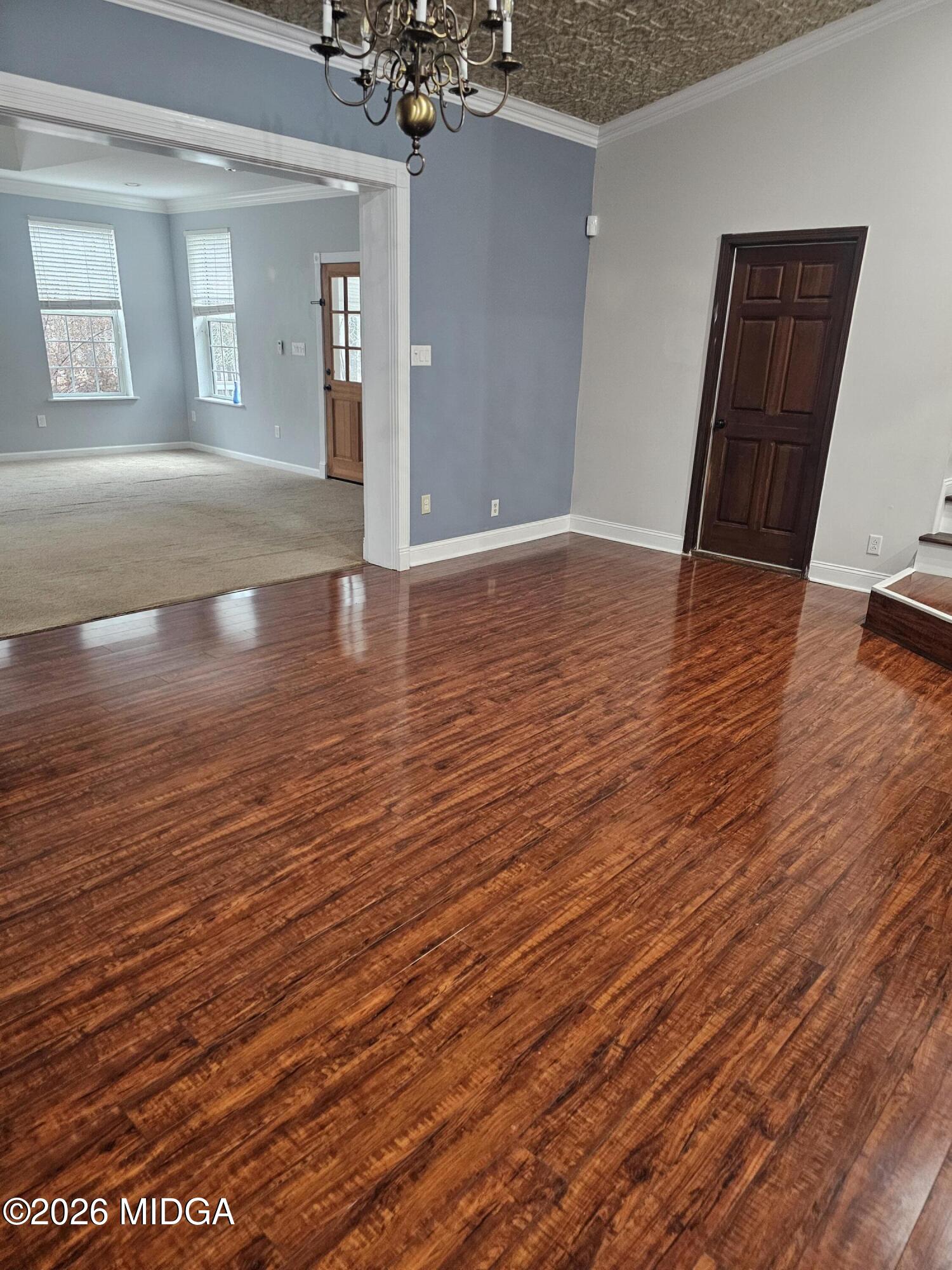 354 Pineview Road Gray, GA 31032 - Photo 36 of 44 an empty room with wooden floor and staircase