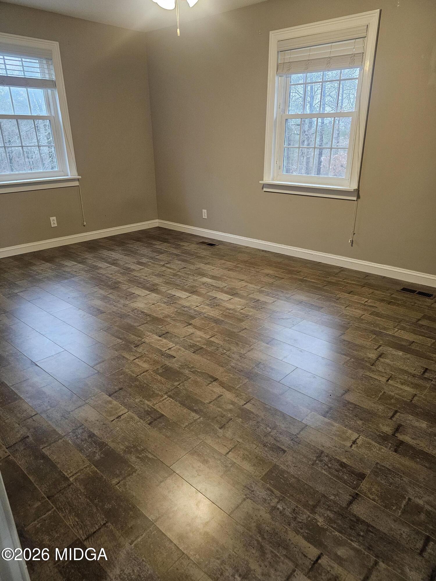 354 Pineview Road Gray, GA 31032 - Photo 42 of 44 an empty room with wooden floor and windows