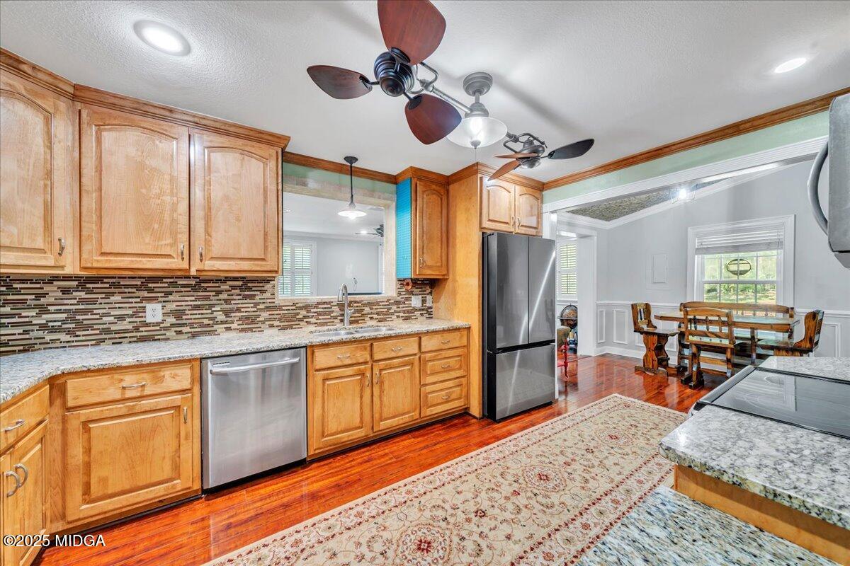 354 Pineview Road Gray, GA 31032 - Photo 9 of 44 a kitchen with stainless steel appliances granite countertop a refrigerator a sink dishwasher a stove and white cabinets with wooden floor