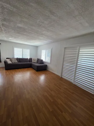a view of a livingroom with furniture and wooden floor