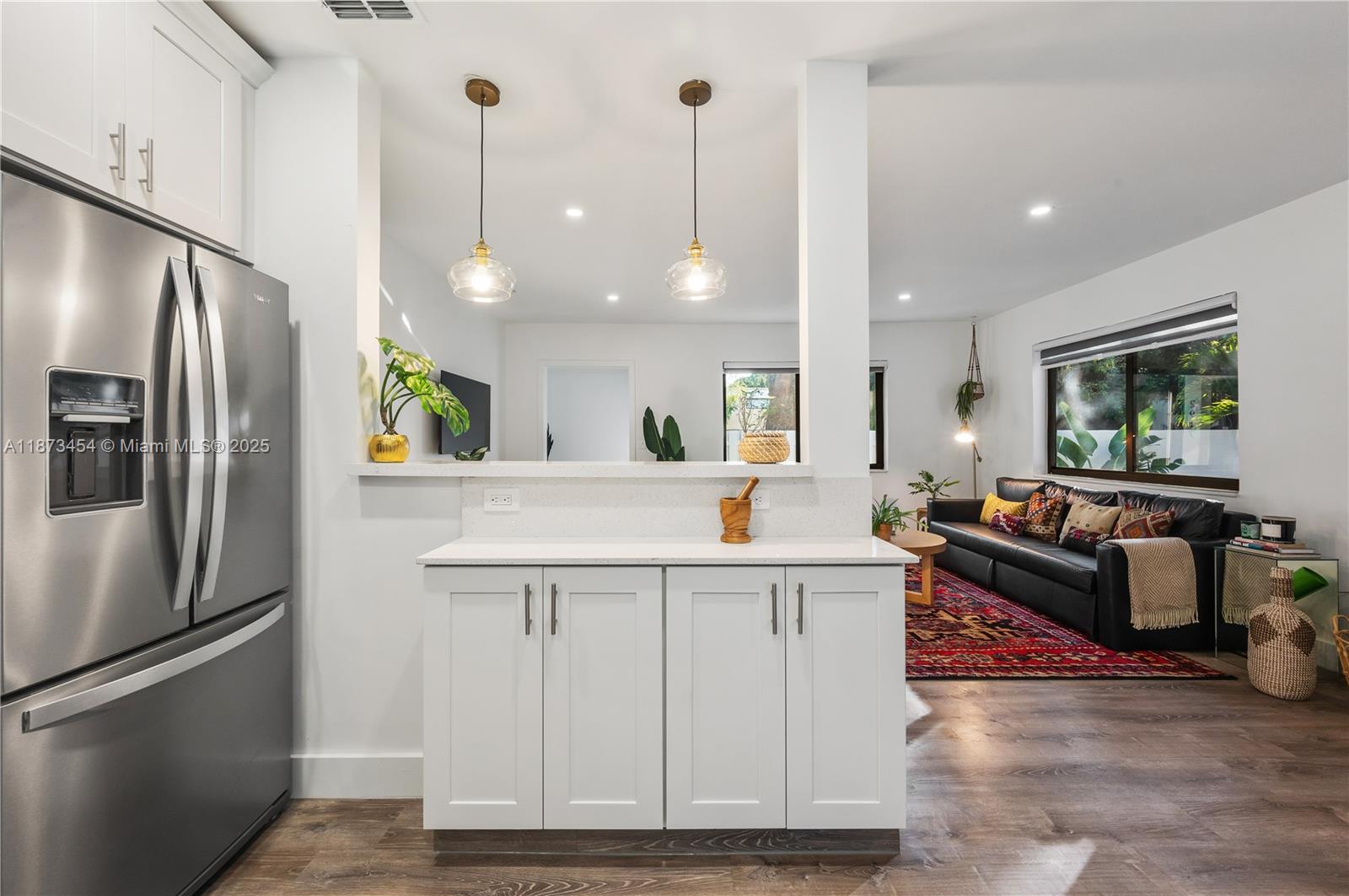 2917 Center Street Miami, FL 33133 - Photo 11 of 32 a kitchen with stainless steel appliances kitchen island granite countertop a refrigerator a oven a sink and a refrigerator