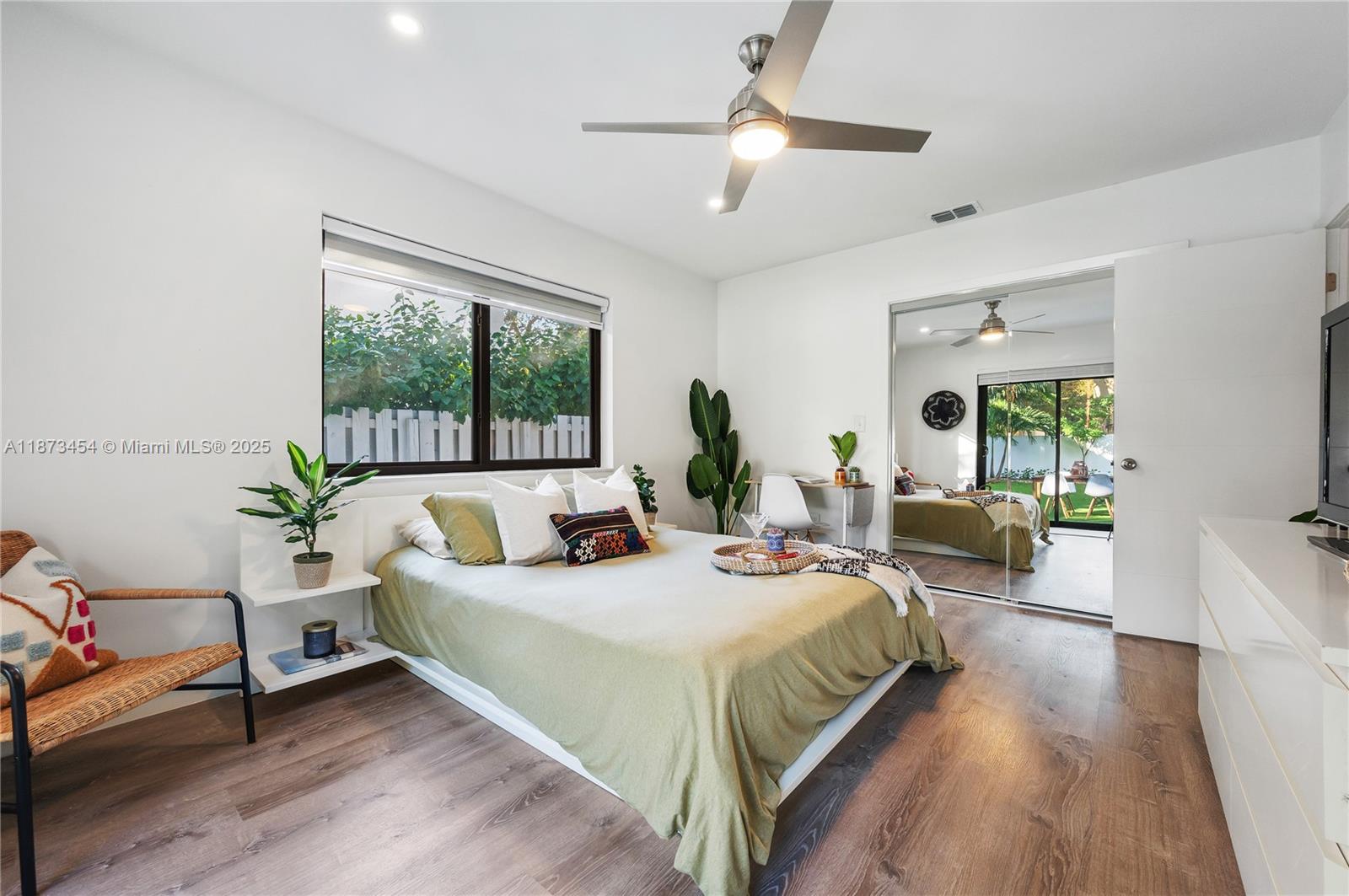 2917 Center Street Miami, FL 33133 - Photo 17 of 32 a spacious bedroom with a large bed and a chandelier