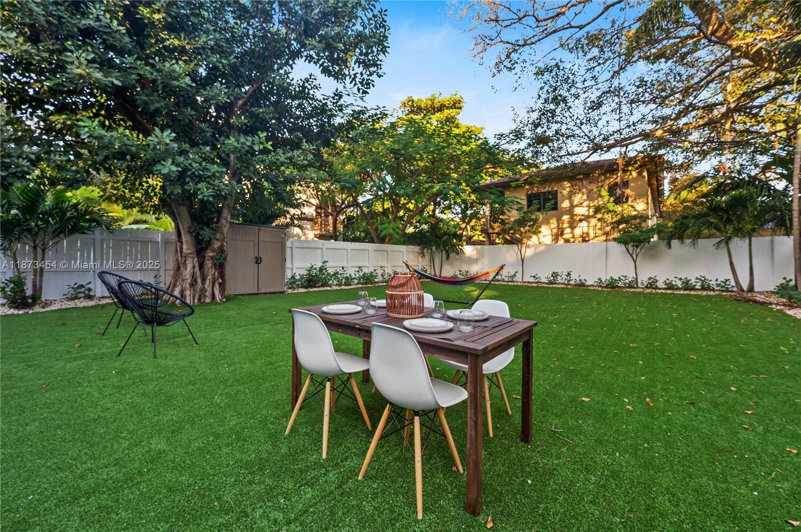 2917 Center Street Miami, FL 33133 - Photo 24 of 32 a view of a backyard with table and chairs and a tree
