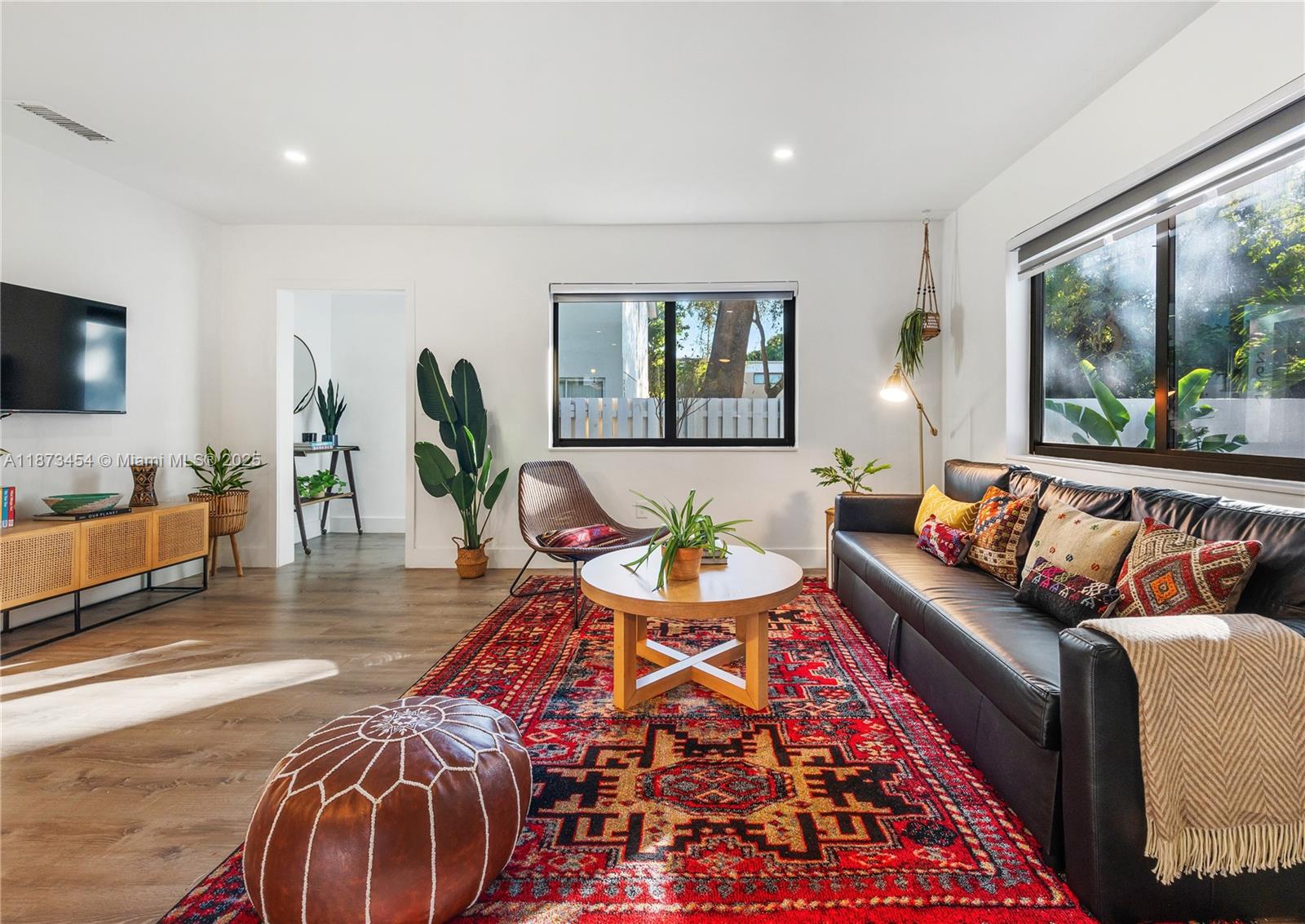 2917 Center Street Miami, FL 33133 - Photo 6 of 32 a living room with furniture and a flat screen tv
