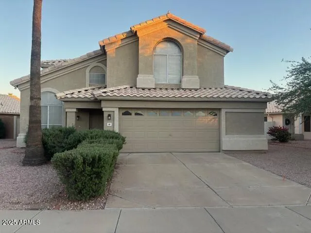 a front view of a house with garage