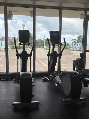 a room with gym equipment and a large window