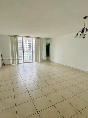 a view of an empty room and a window