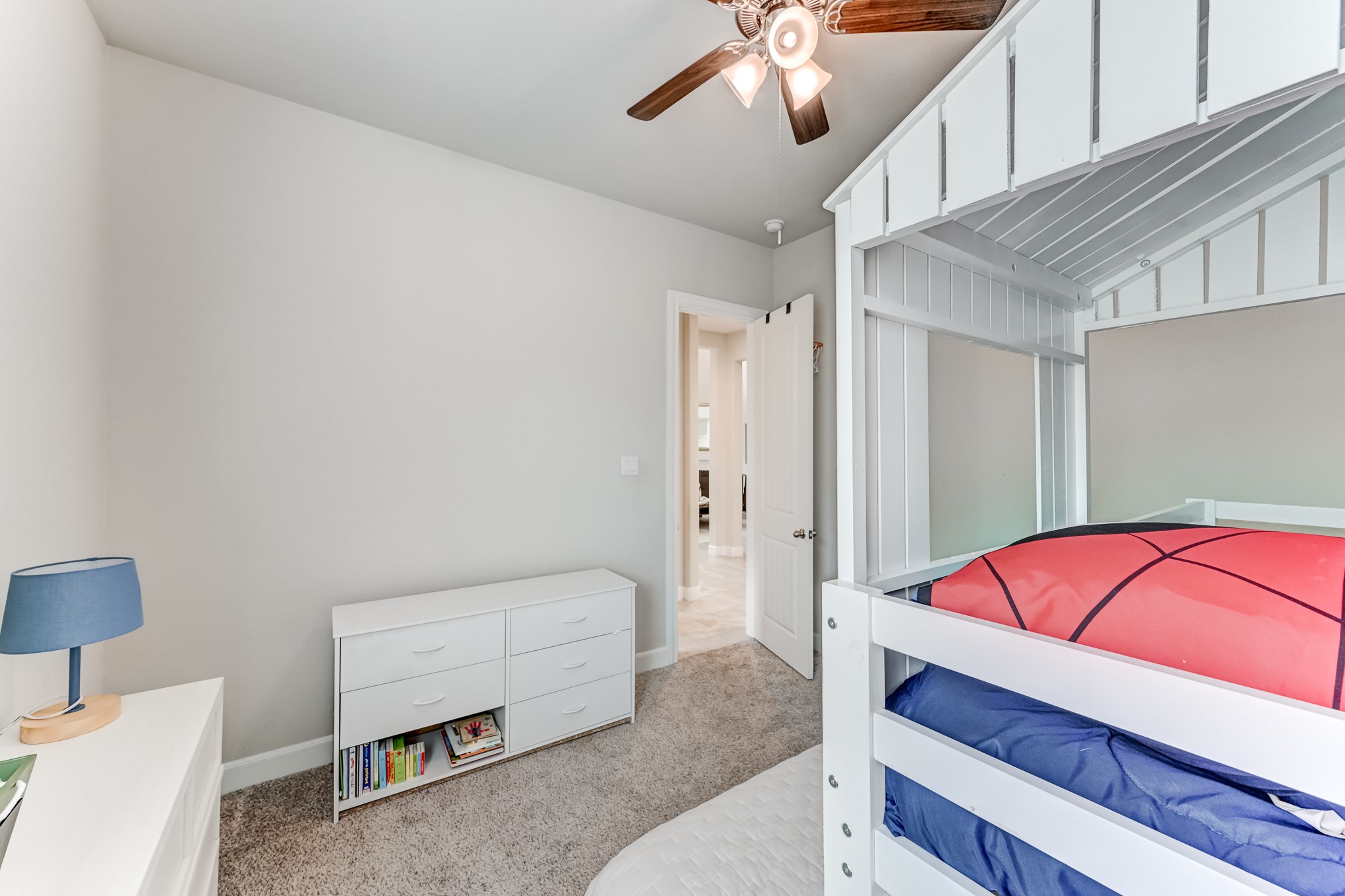 5806 Metaphor Way Rosenberg, TX 77469 - Photo 29 of 50 a living room with a bed and a chandelier