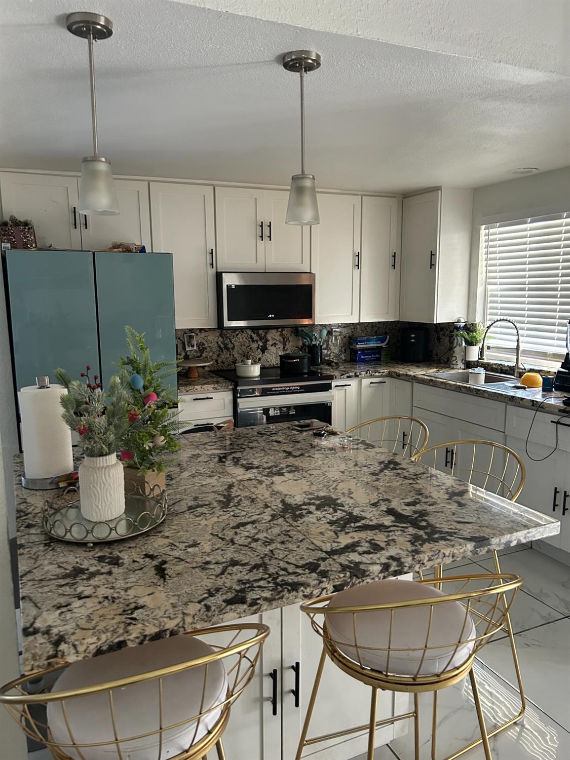 629 E Fort Modesto, CA 95354 - Photo 3 of 16 a kitchen with stainless steel appliances granite countertop a stove a sink a microwave a refrigerator and white cabinets