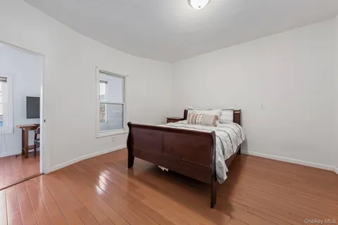 a bed sitting in a spacious bedroom next to a window