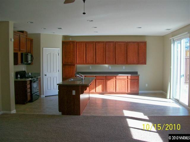460 Teramo Court Reno, NV 89521 - Photo 4 of 13 a kitchen with stainless steel appliances granite countertop a refrigerator and a stove