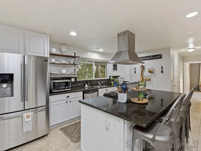 6460 Rainbow Heights Road Fallbrook, CA 92028 - Photo 14 of 38 a kitchen with stainless steel appliances granite countertop a sink a stove and a refrigerator