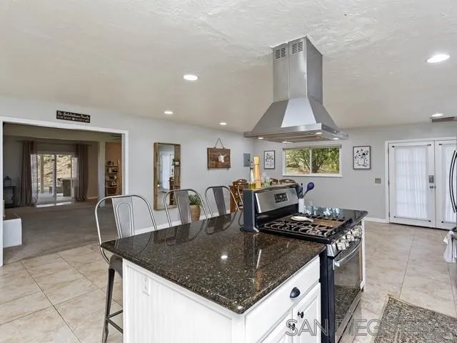 6460 Rainbow Heights Road Fallbrook, CA 92028 - Photo 15 of 38 a kitchen with a stove a table and chairs
