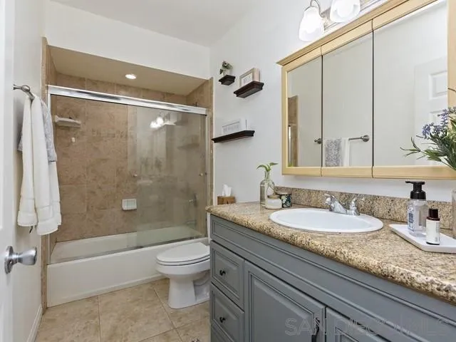 6460 Rainbow Heights Road Fallbrook, CA 92028 - Photo 20 of 38 a bathroom with a granite countertop sink toilet mirror and shower