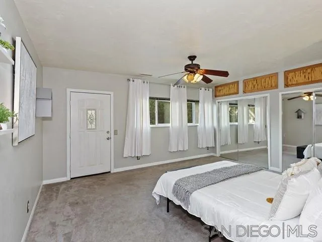 6460 Rainbow Heights Road Fallbrook, CA 92028 - Photo 21 of 38 a bedroom with a bed and a chandelier