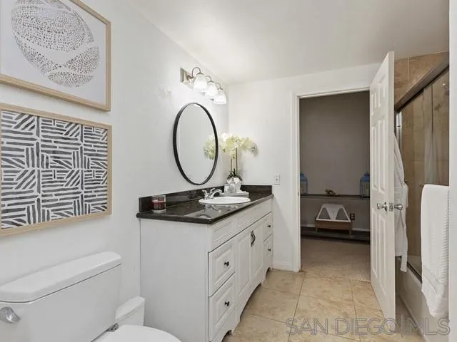 6460 Rainbow Heights Road Fallbrook, CA 92028 - Photo 22 of 38 a bathroom with a toilet a sink and a mirror