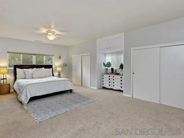 6460 Rainbow Heights Road Fallbrook, CA 92028 - Photo 23 of 38 a bedroom with a bed and a chandelier