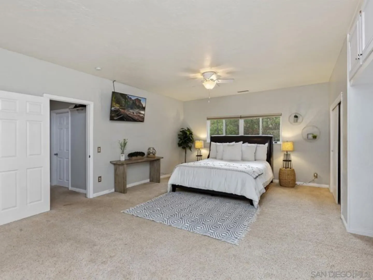 6460 Rainbow Heights Road Fallbrook, CA 92028 - Photo 24 of 38 a spacious bedroom with a bed and a flat screen tv