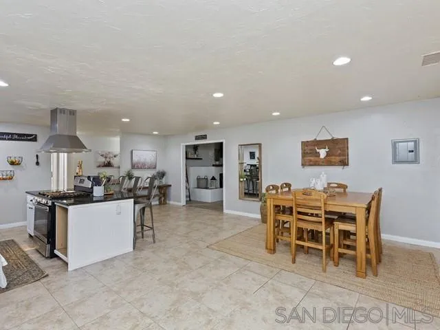 6460 Rainbow Heights Road Fallbrook, CA 92028 - Photo 10 of 38 a kitchen with a dining table chairs and stainless steel appliances