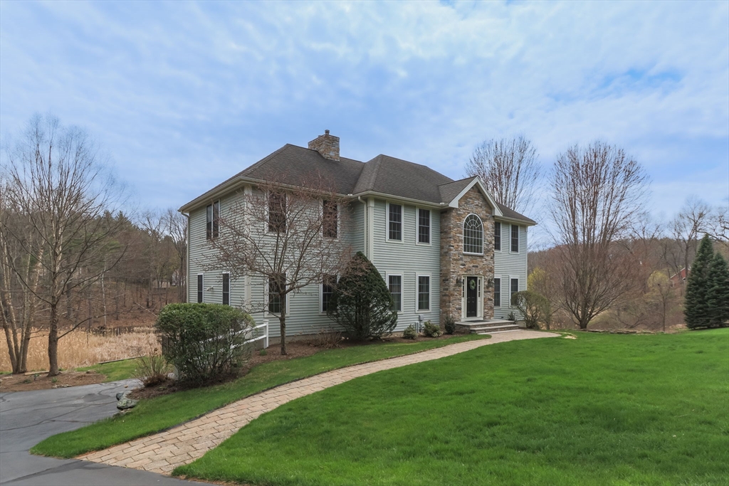 256 Lowell Road Groton, MA 01450 - Photo 1 of 40 a front view of a house with garden