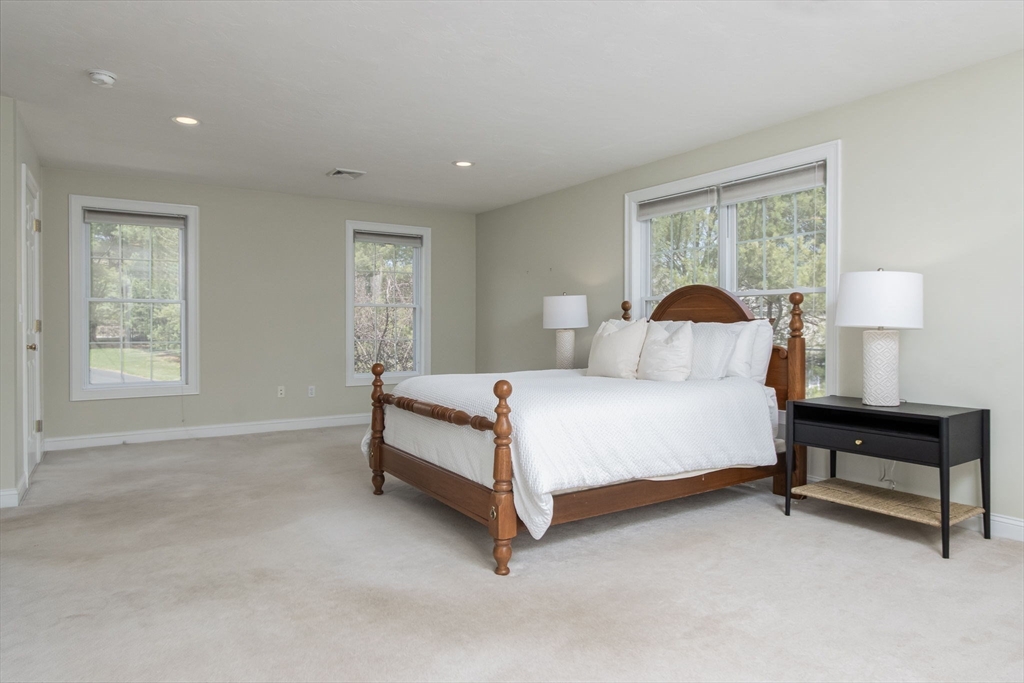 256 Lowell Road Groton, MA 01450 - Photo 22 of 40 a bedroom with a bed and a lamp on table
