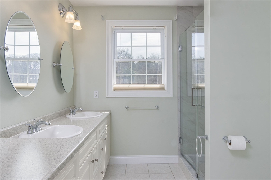 256 Lowell Road Groton, MA 01450 - Photo 24 of 40 a bathroom with a double vanity sink mirror and a bathtub